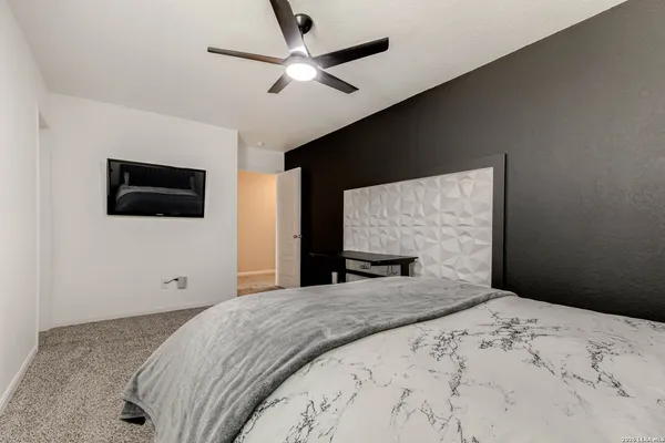 a bedroom with a bed and a flat screen tv