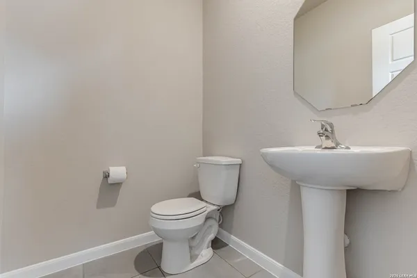 a bathroom with a sink toilet and a mirror