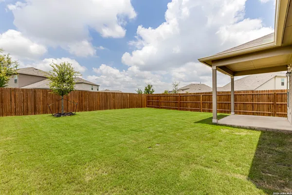 a view of a house with backyard and porch