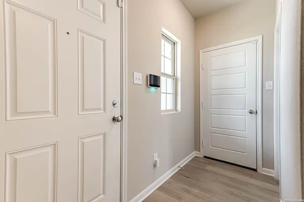 a view of an empty room with closet and a window