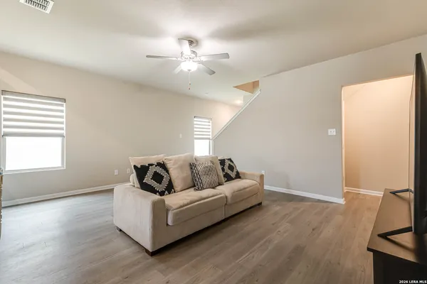 a living room with furniture and wooden floor