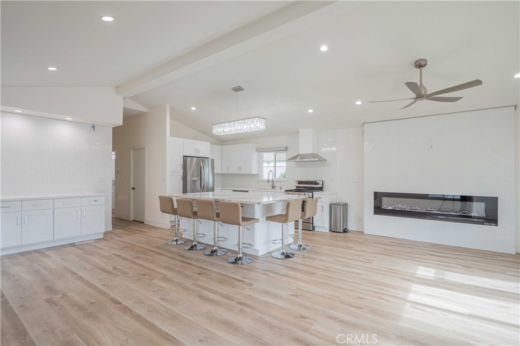 1120 East Mission Road, Unit 80 Fallbrook, CA 92028 - Photo 1 of 1 a living room with kitchen island furniture and a wooden floor