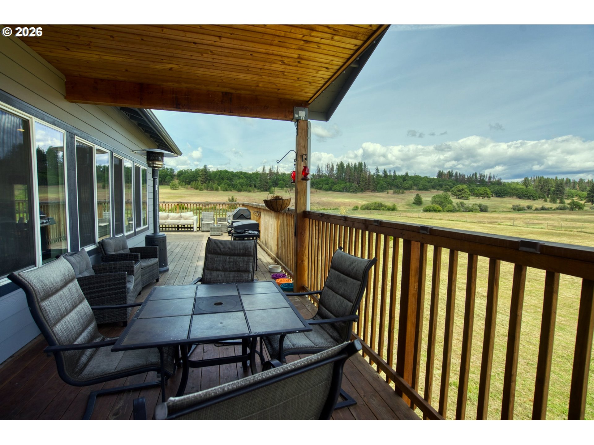 19 Inverness Road Goldendale, WA 98620 - Photo 45 of 48 a view of a patio with lawn chairs floor to ceiling window and floor to ceiling window