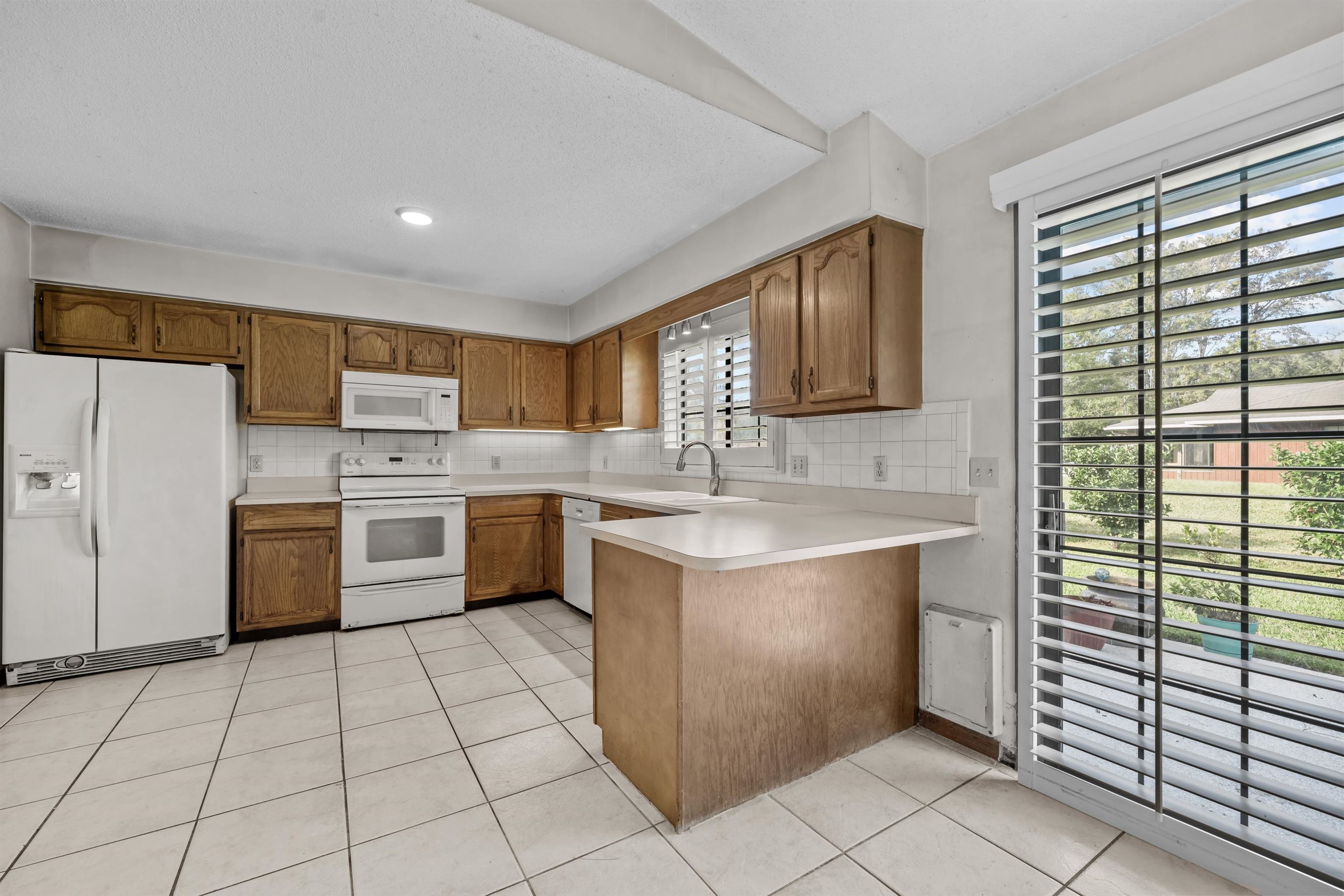 240 Watson Road St. Augustine, FL 32086 - Photo 13 of 43 a kitchen with a stove a sink and a refrigerator