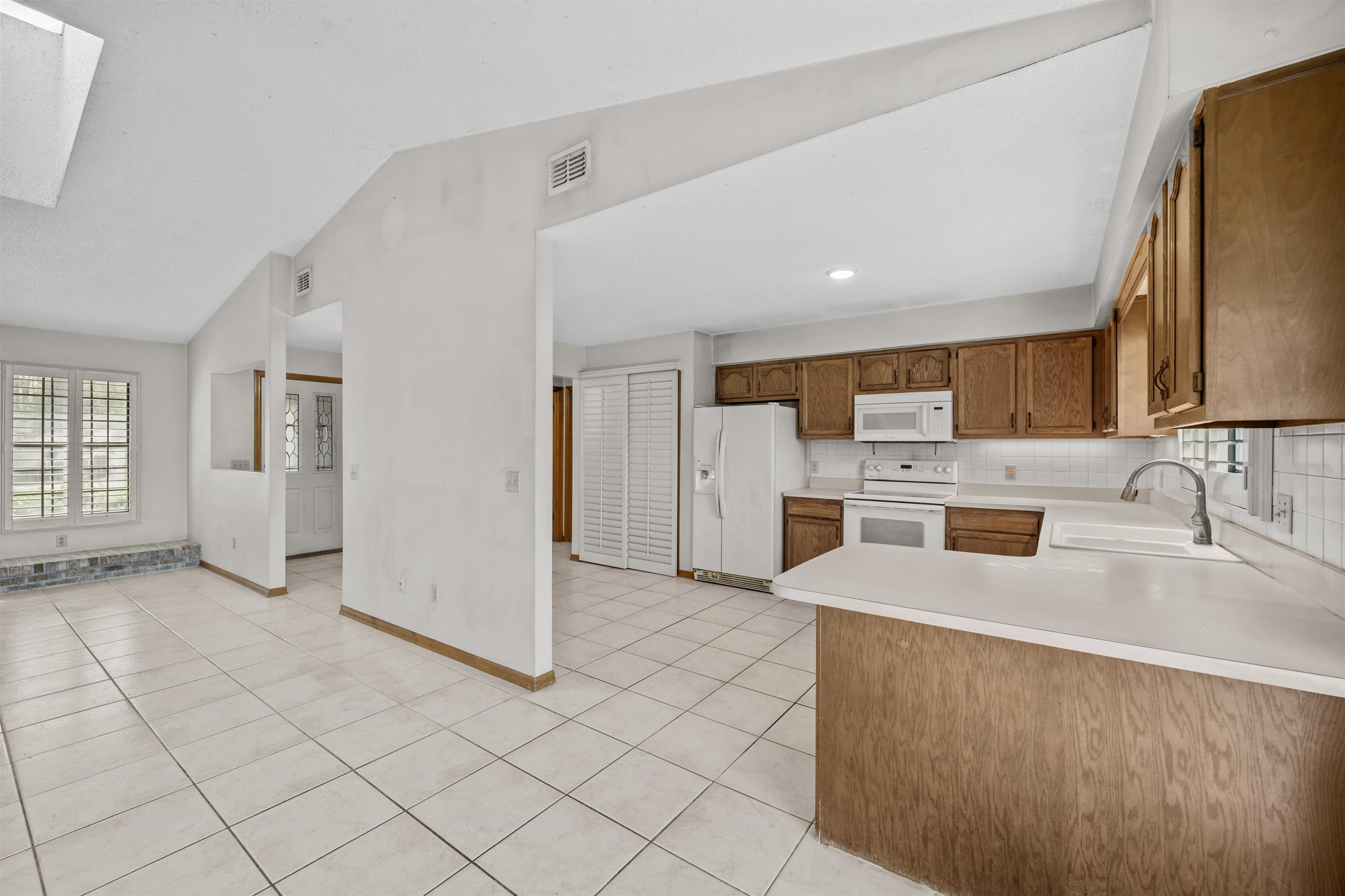 240 Watson Road St. Augustine, FL 32086 - Photo 14 of 43 a kitchen with stainless steel appliances a sink a stove a refrigerator a sink and cabinets