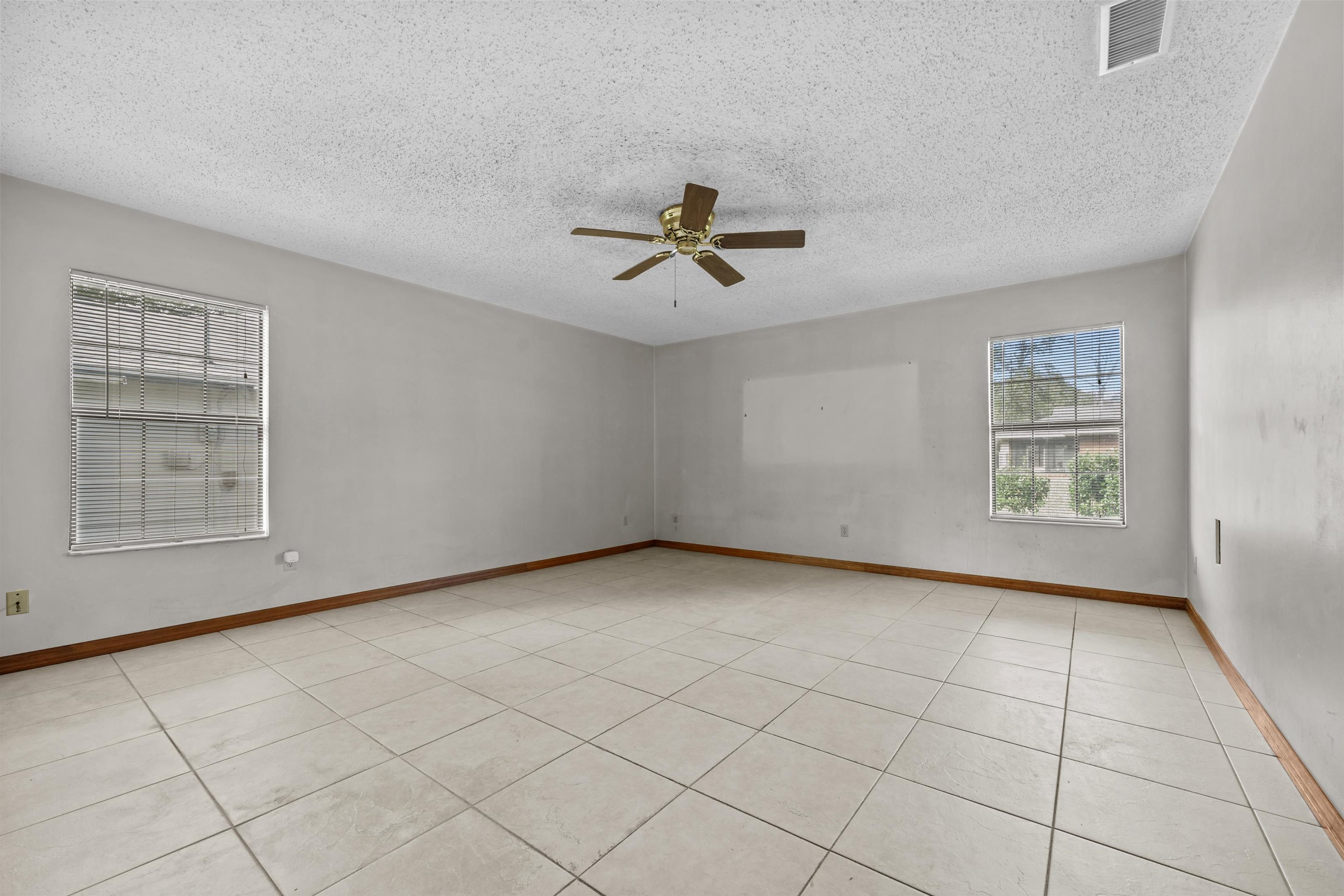 240 Watson Road St. Augustine, FL 32086 - Photo 18 of 43 an empty room with windows and chandelier fan