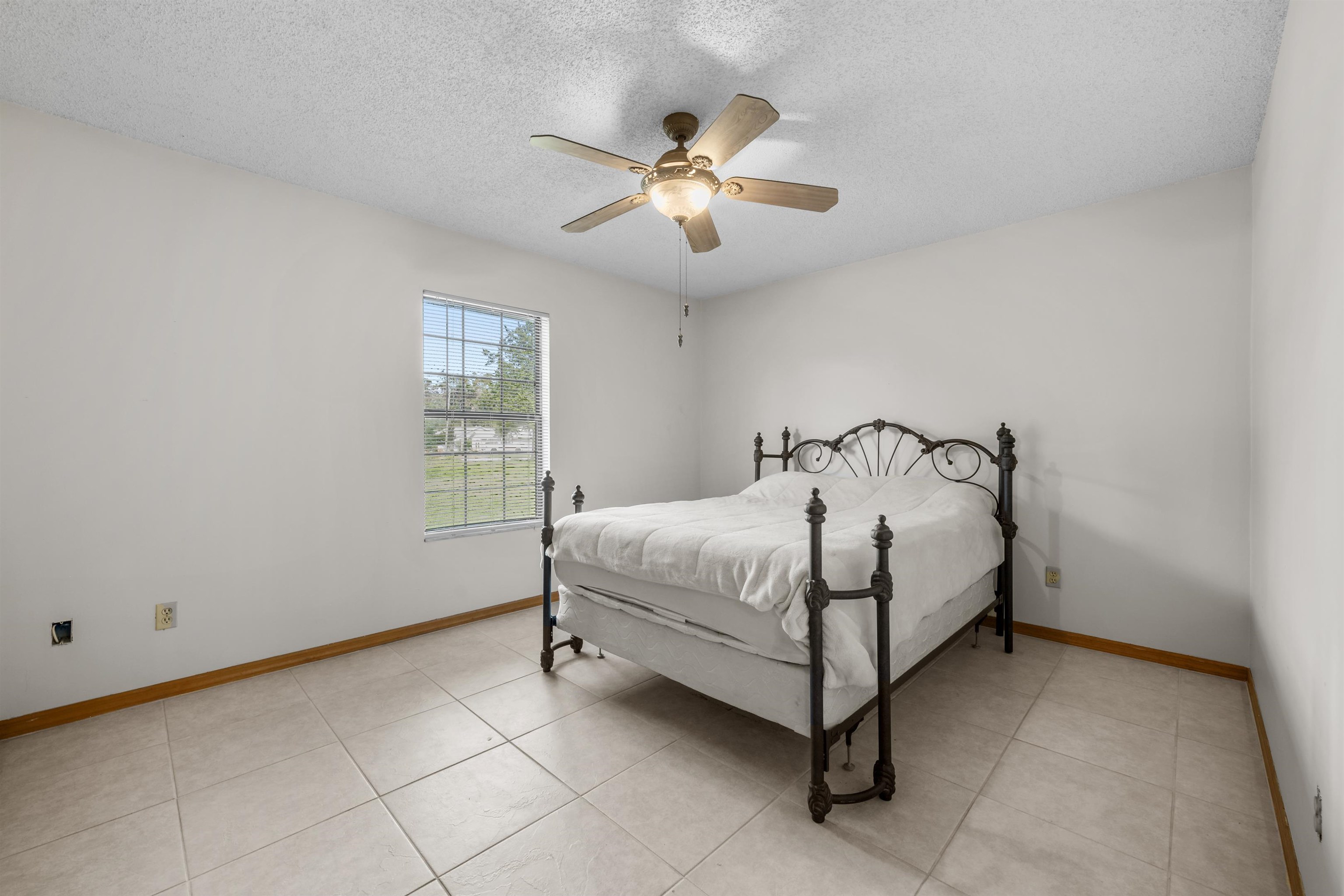 240 Watson Road St. Augustine, FL 32086 - Photo 24 of 43 a bed sitting in a bedroom next to a window