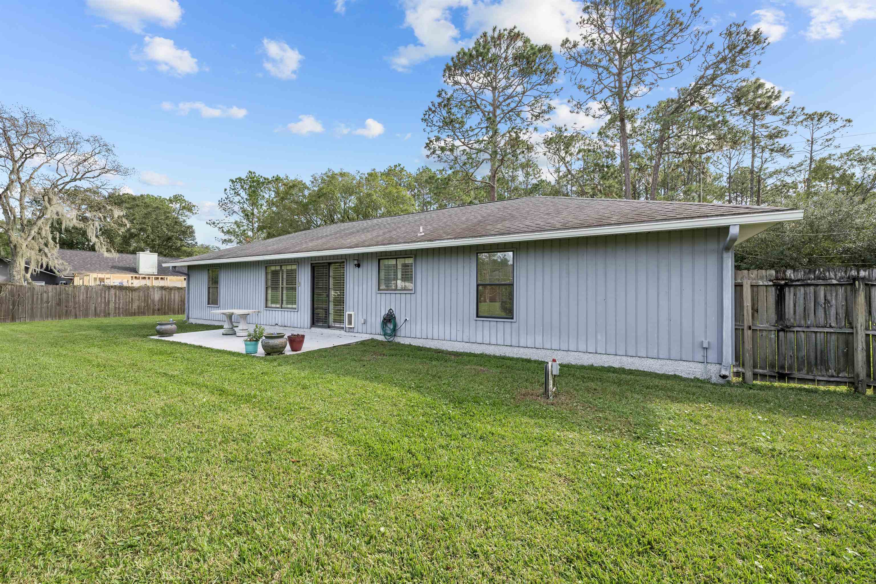 240 Watson Road St. Augustine, FL 32086 - Photo 32 of 43 a backyard of a house with table and chairs