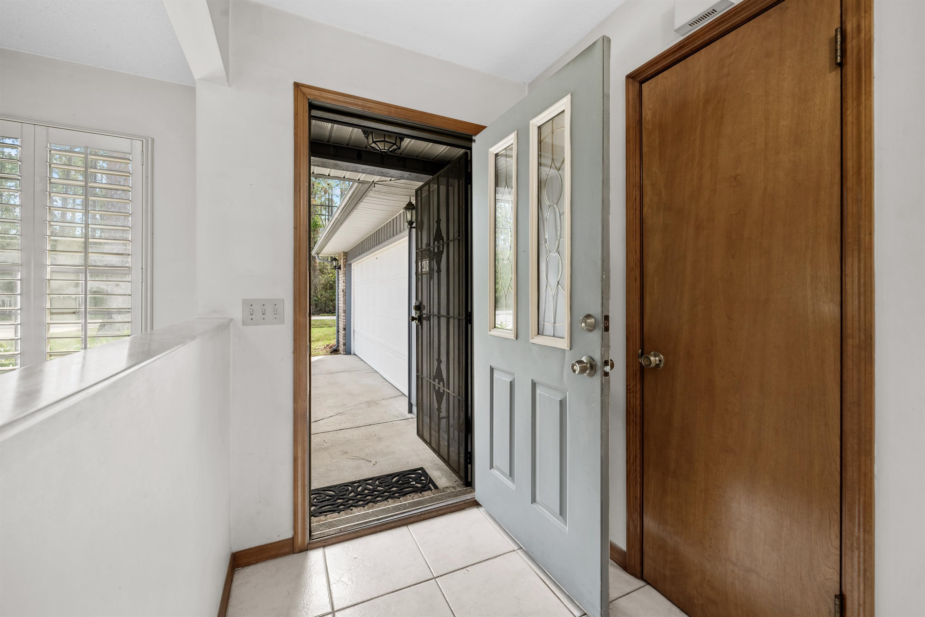 240 Watson Road St. Augustine, FL 32086 - Photo 4 of 43 a view of a hallway with wooden floor and a living room
