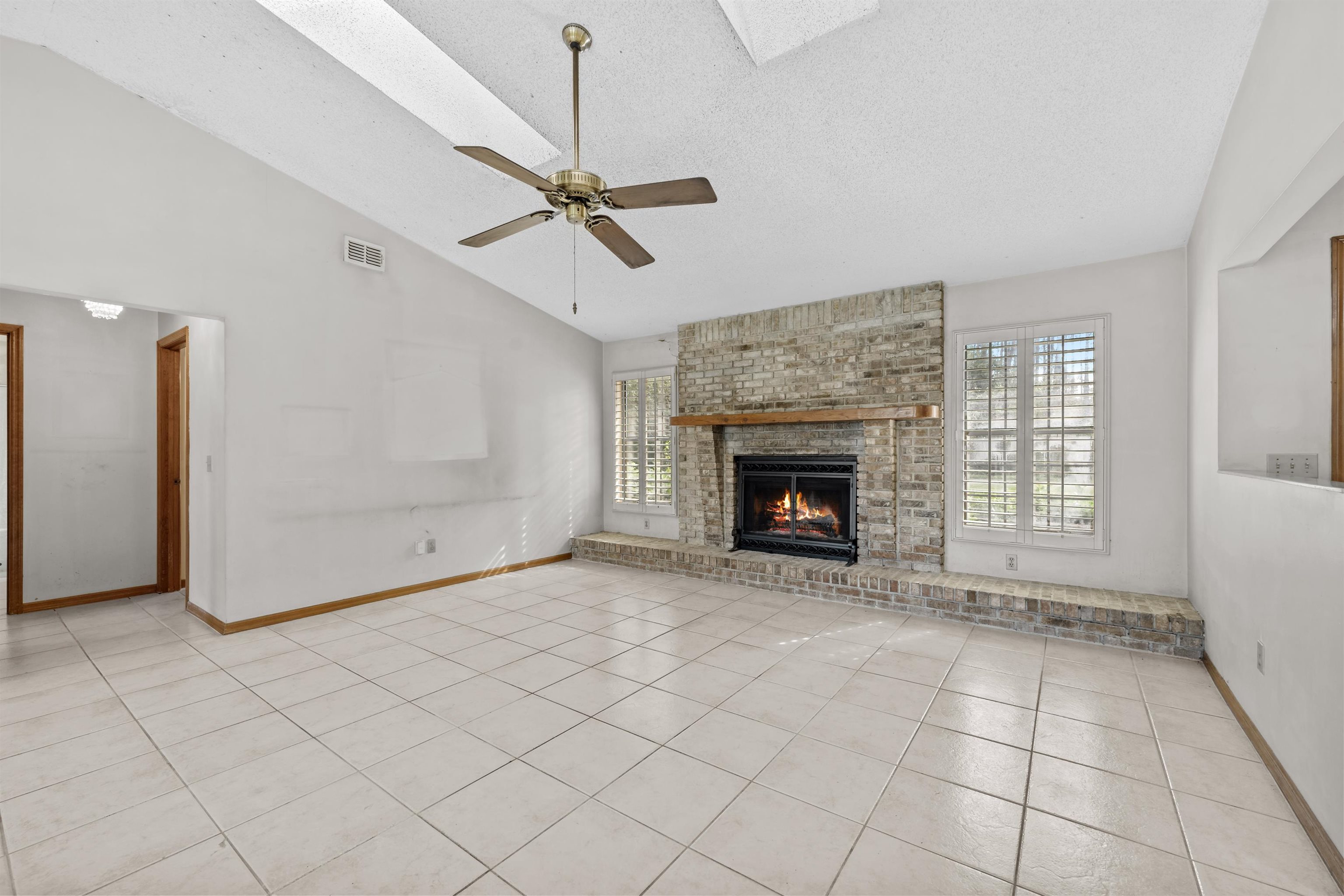 240 Watson Road St. Augustine, FL 32086 - Photo 6 of 43 a view of an empty room with window and fire place