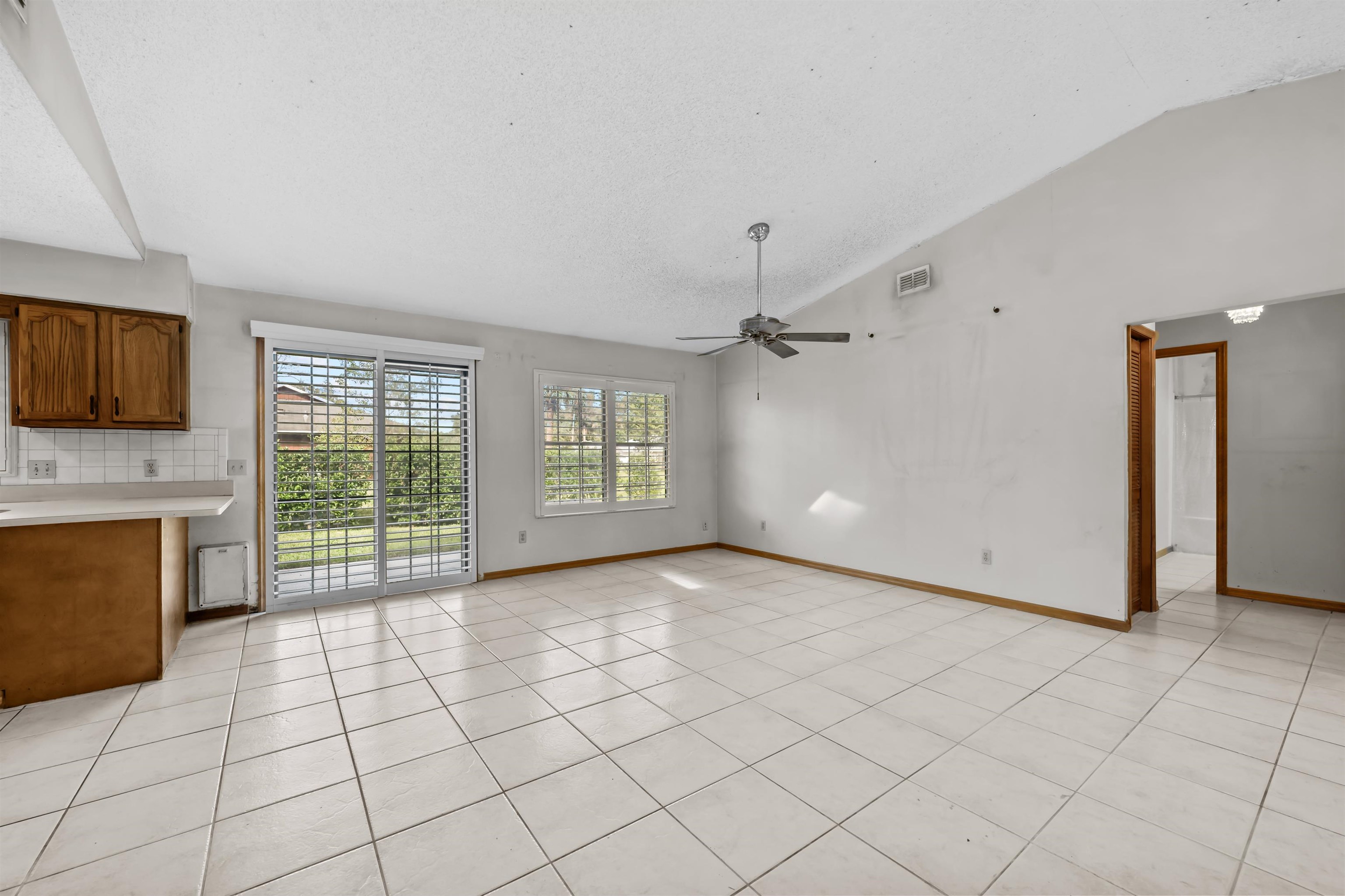 240 Watson Road St. Augustine, FL 32086 - Photo 10 of 43 a view of an empty room with a fireplace and a window