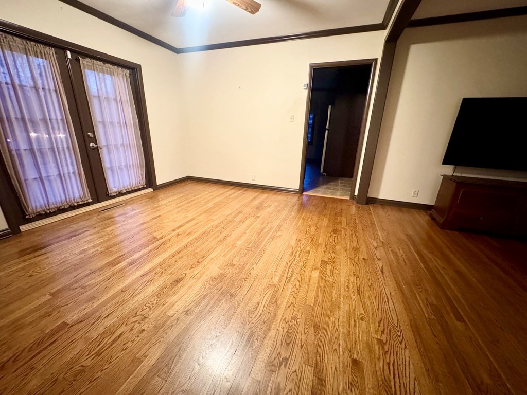 147 Berry Street Camden, TN 38320 - Photo 12 of 16 a view of empty room with wooden floor and stairs