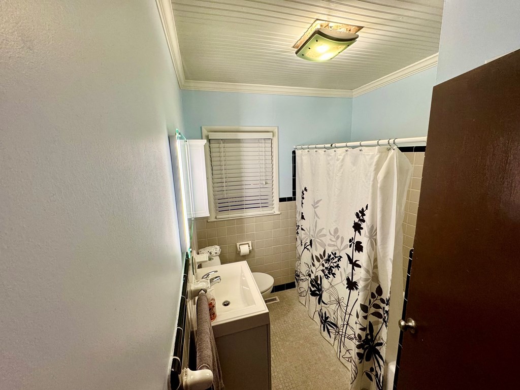 147 Berry Street Camden, TN 38320 - Photo 13 of 16 a bathroom with a sink and shower curtain