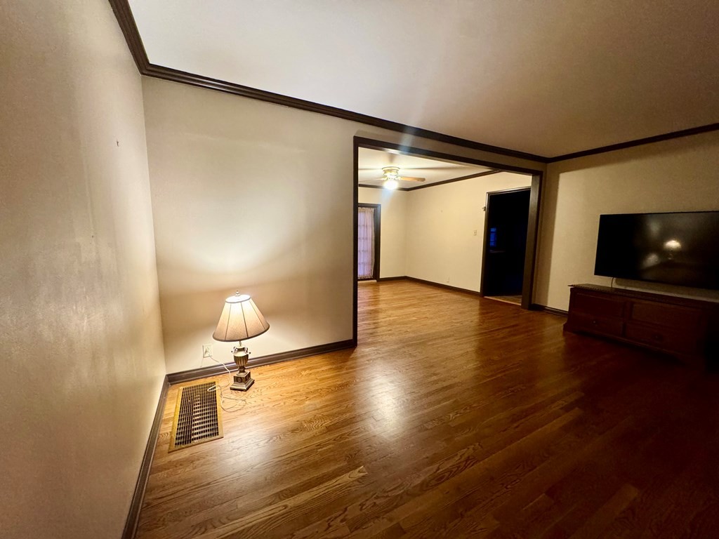 147 Berry Street Camden, TN 38320 - Photo 6 of 16 a view of empty room with wooden floor