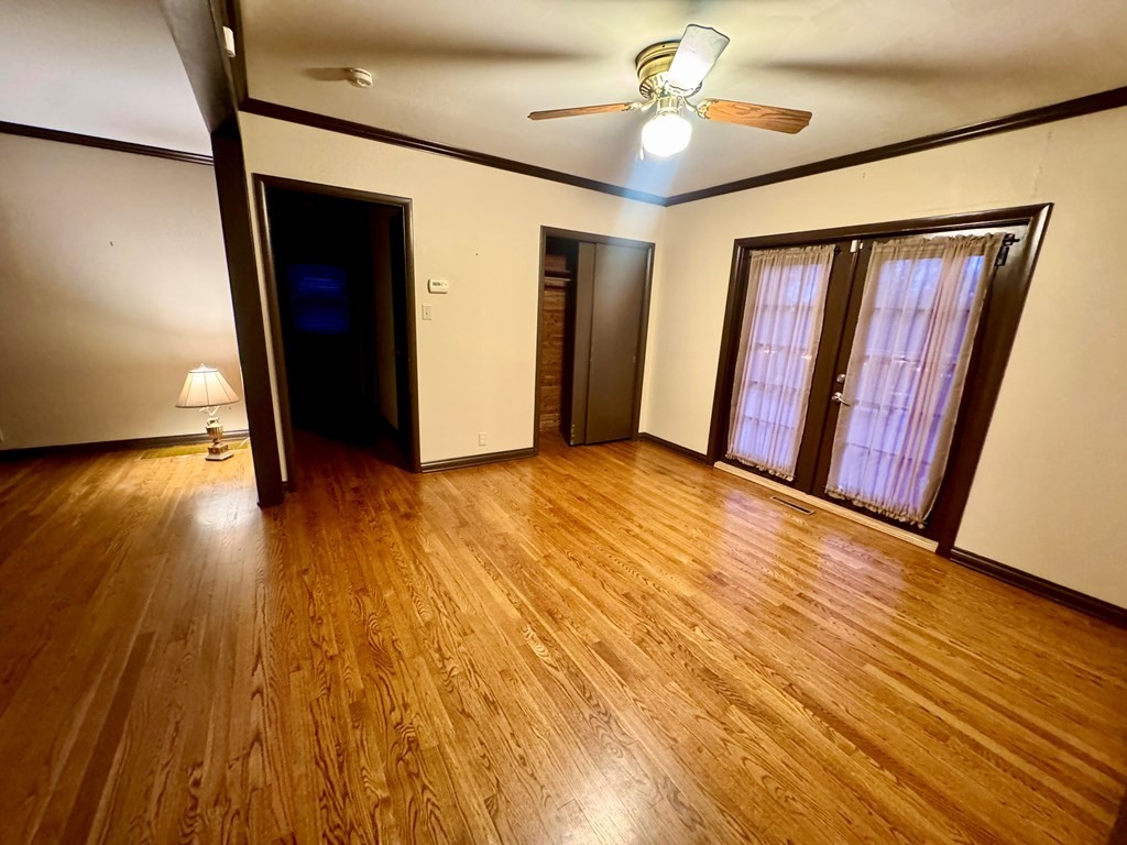 147 Berry Street Camden, TN 38320 - Photo 9 of 16 a view of empty room with wooden floor and fan