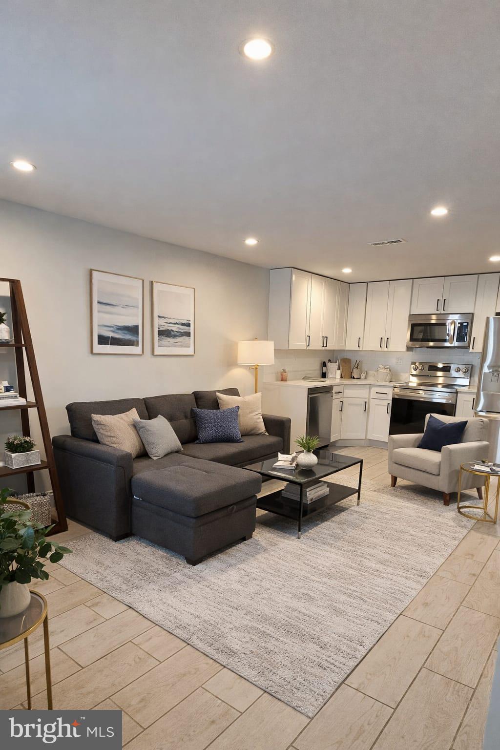 a living room with furniture and kitchen view