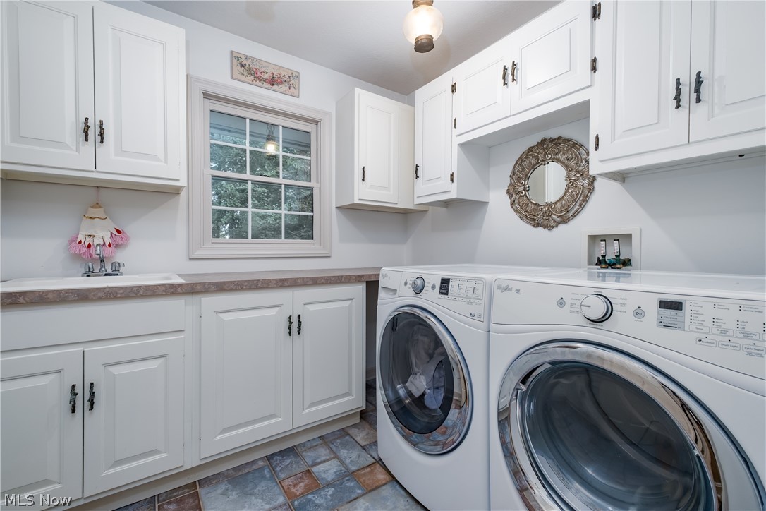 3151 Perry Drive Northwest Canton, OH 44708 - Photo 38 of 49 Laundry room with washer and clothes dryer, cabinet space, and stone finish floors