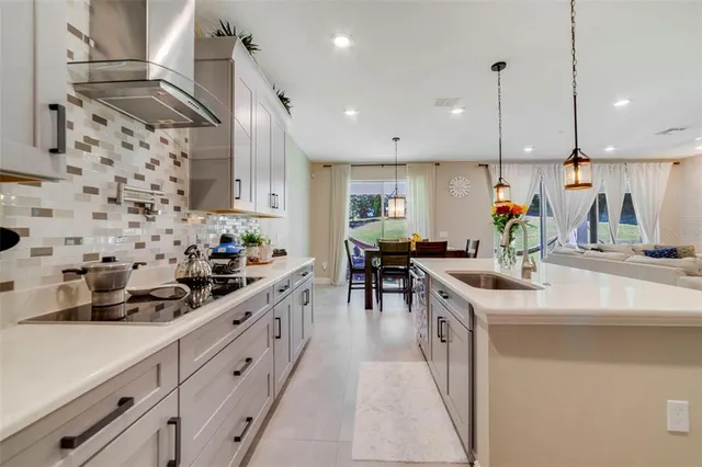 a kitchen with stainless steel appliances kitchen island granite countertop a sink and cabinets