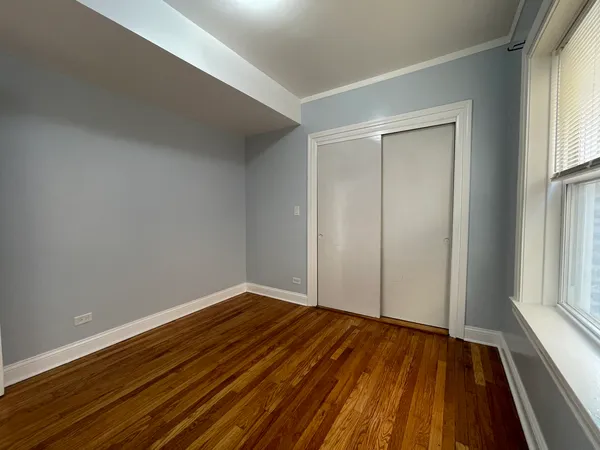 a view of room with window and wooden floor