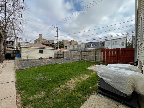 a view of a backyard with sitting area
