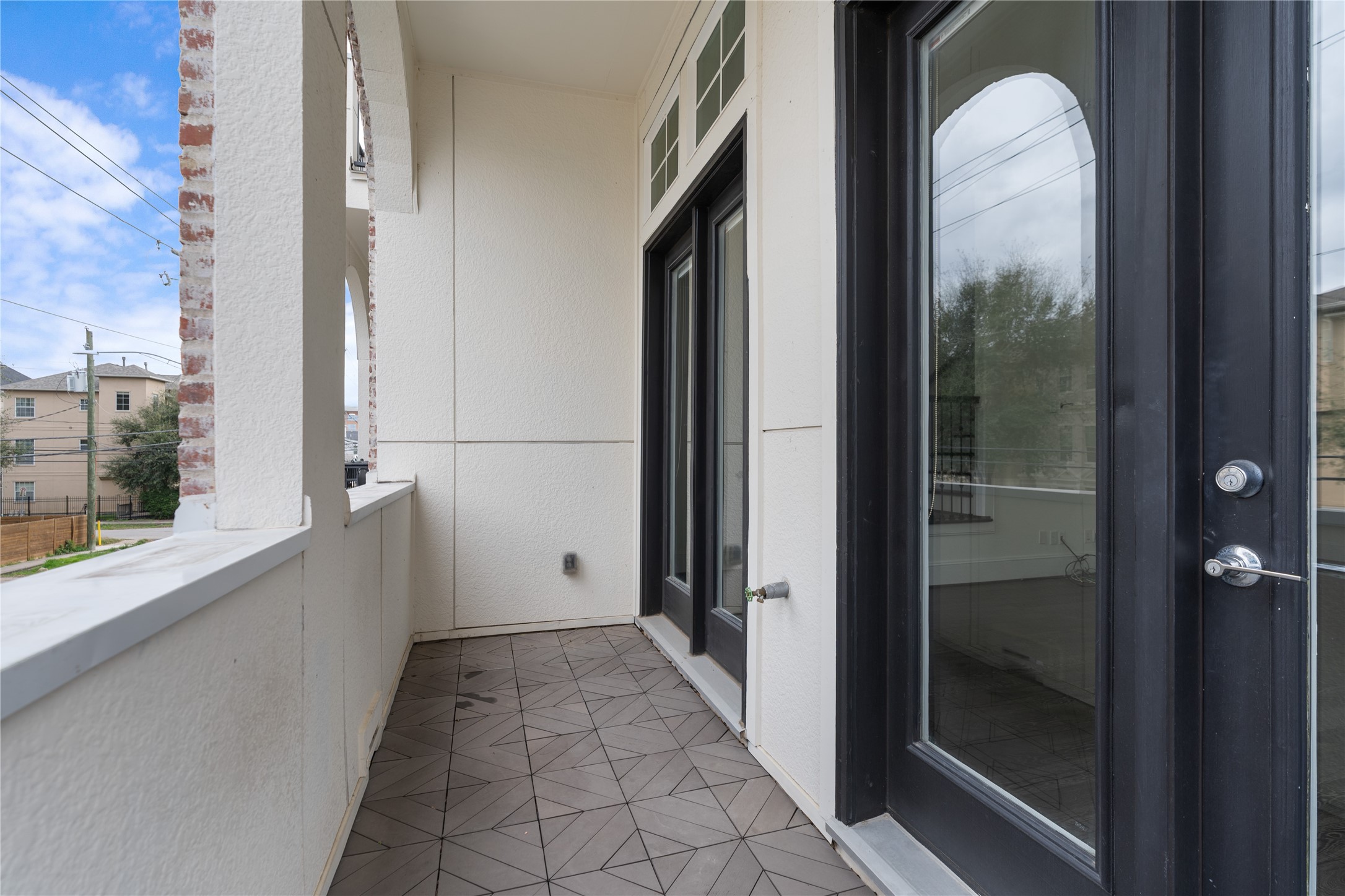 2613 Maxroy Street Houston, TX 77007 - Photo 18 of 42 French doors open to a private balcony, extending the living space outdoors and creating an effortless indoor-outdoor flow.