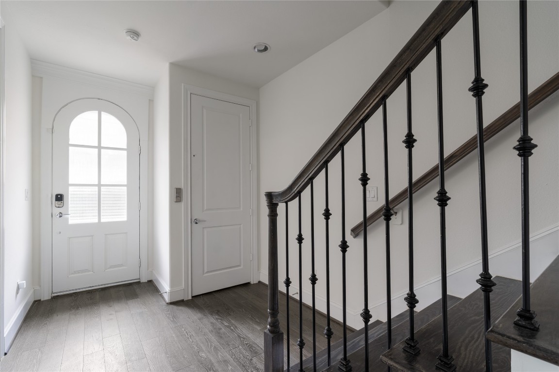 2613 Maxroy Street Houston, TX 77007 - Photo 33 of 42 The welcoming foyer is anchored by a striking arched front door and offers convenient access to multiple areas of the home, including a private bedroom ideal for guests or a home office.