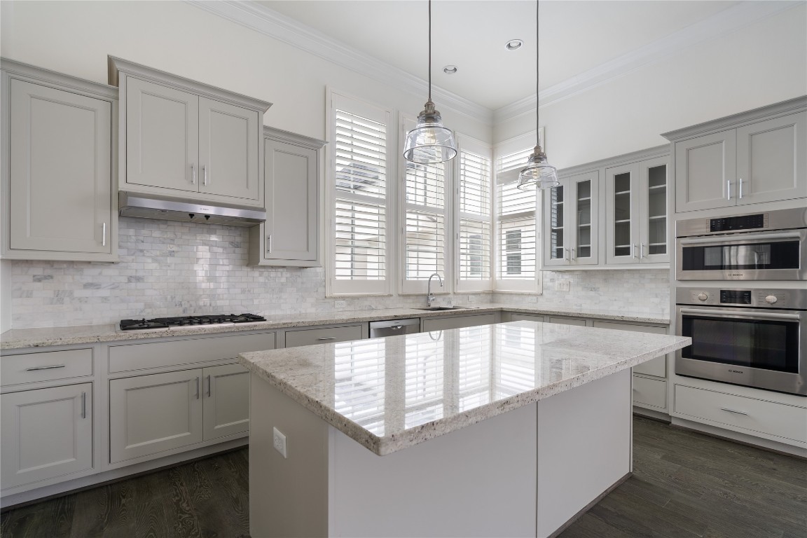 2613 Maxroy Street Houston, TX 77007 - Photo 9 of 42 Well-crafted cabinetry provides ample storage and refined detailing, contributing to the kitchen’s cohesive, polished look.