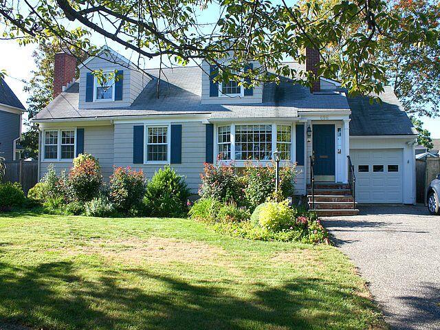696 Beach Road Fairfield, CT 06824 - Photo 1 of 1 a front view of a house with garden