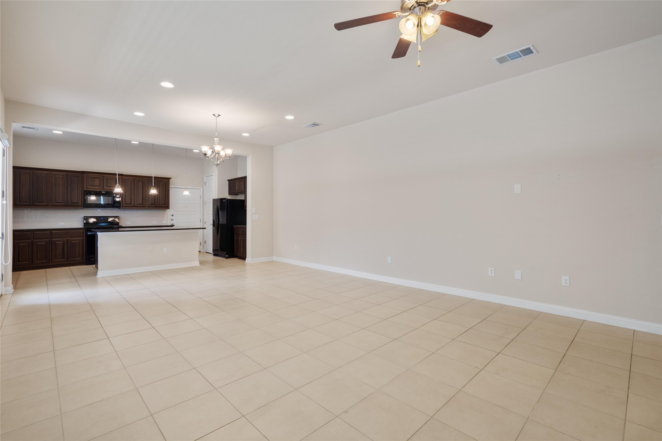 6907 Idea Road Austin, TX 78741 - Photo 33 of 36 an open kitchen with a sink cabinets and appliances