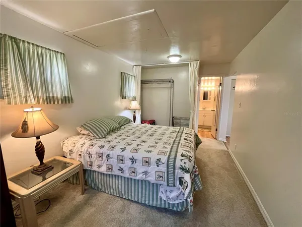 a bedroom with a bed and a mirror