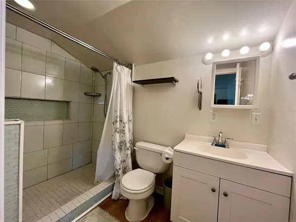 a bathroom with a sink toilet and shower