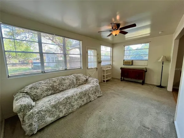 a living room with furniture and a large window