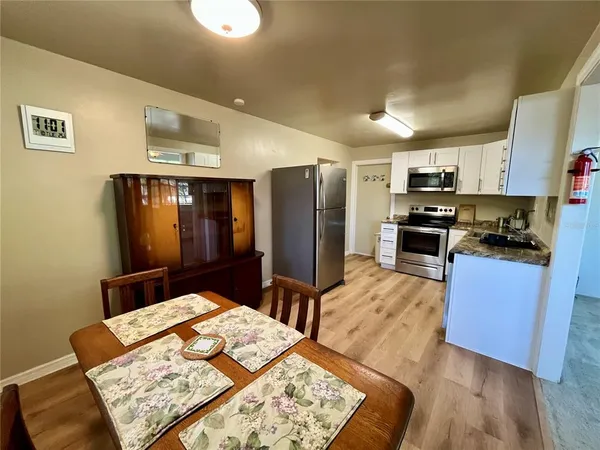 a kitchen with stainless steel appliances kitchen island granite countertop a refrigerator and stove