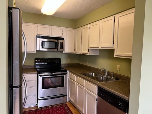 109 North Main Street, Unit 708 Memphis, TN 38103 - Photo 7 of 15 a kitchen with stainless steel appliances a stove a microwave and a sink
