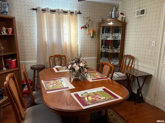 a view of a dining room with furniture and window
