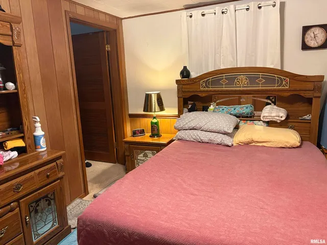 a bedroom with a bed and a television