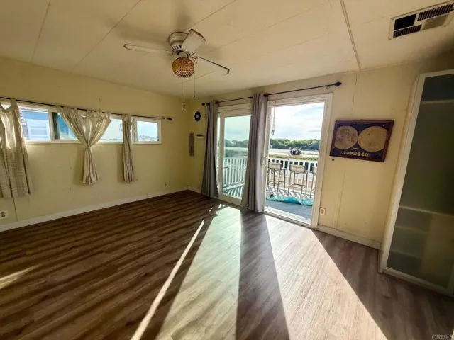 a view of a room with wooden floor