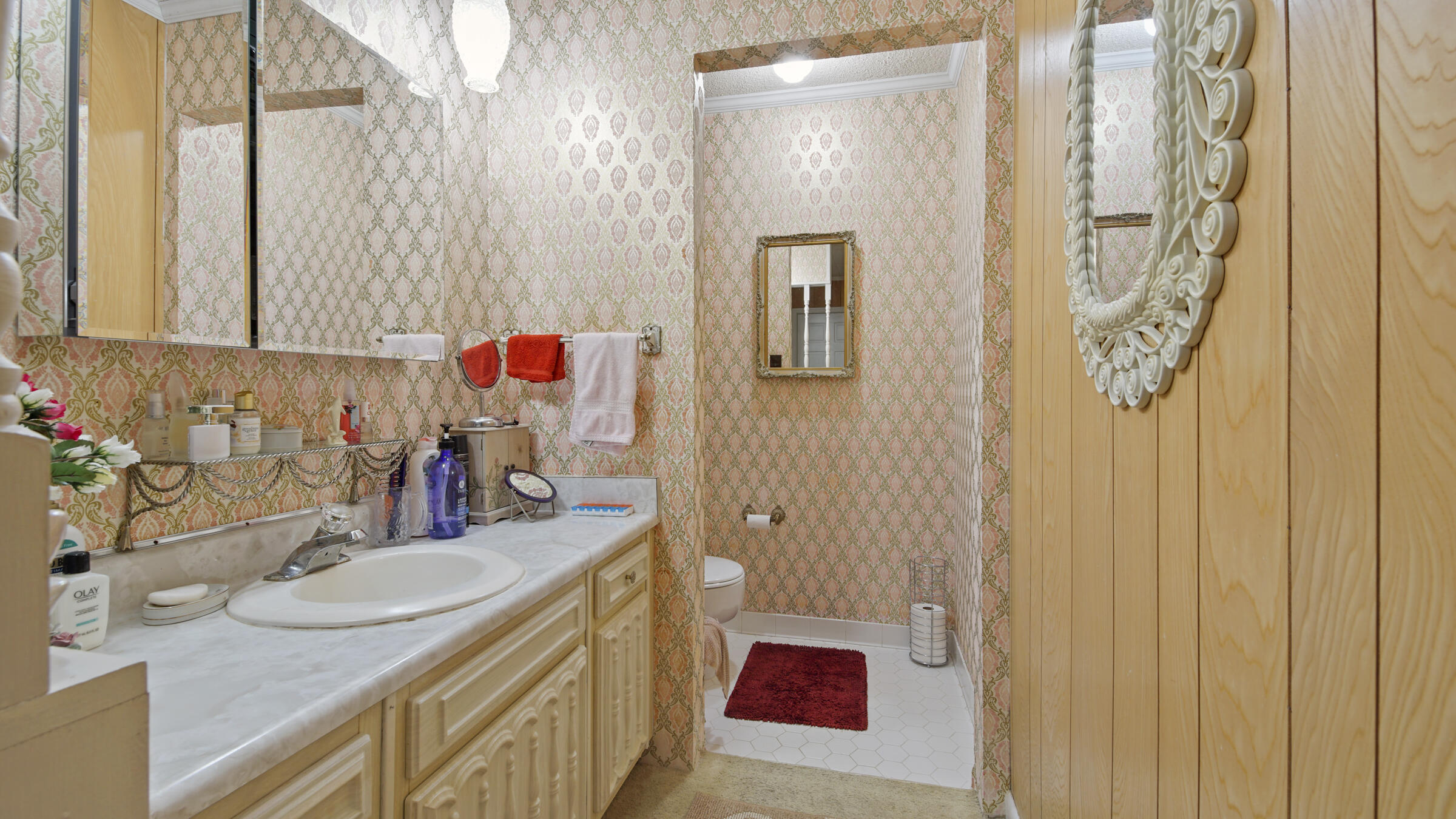 1124 Bay Grove Road Freeport, FL 32439 - Photo 15 of 37 a bathroom with a granite countertop sink a mirror and shower curtain