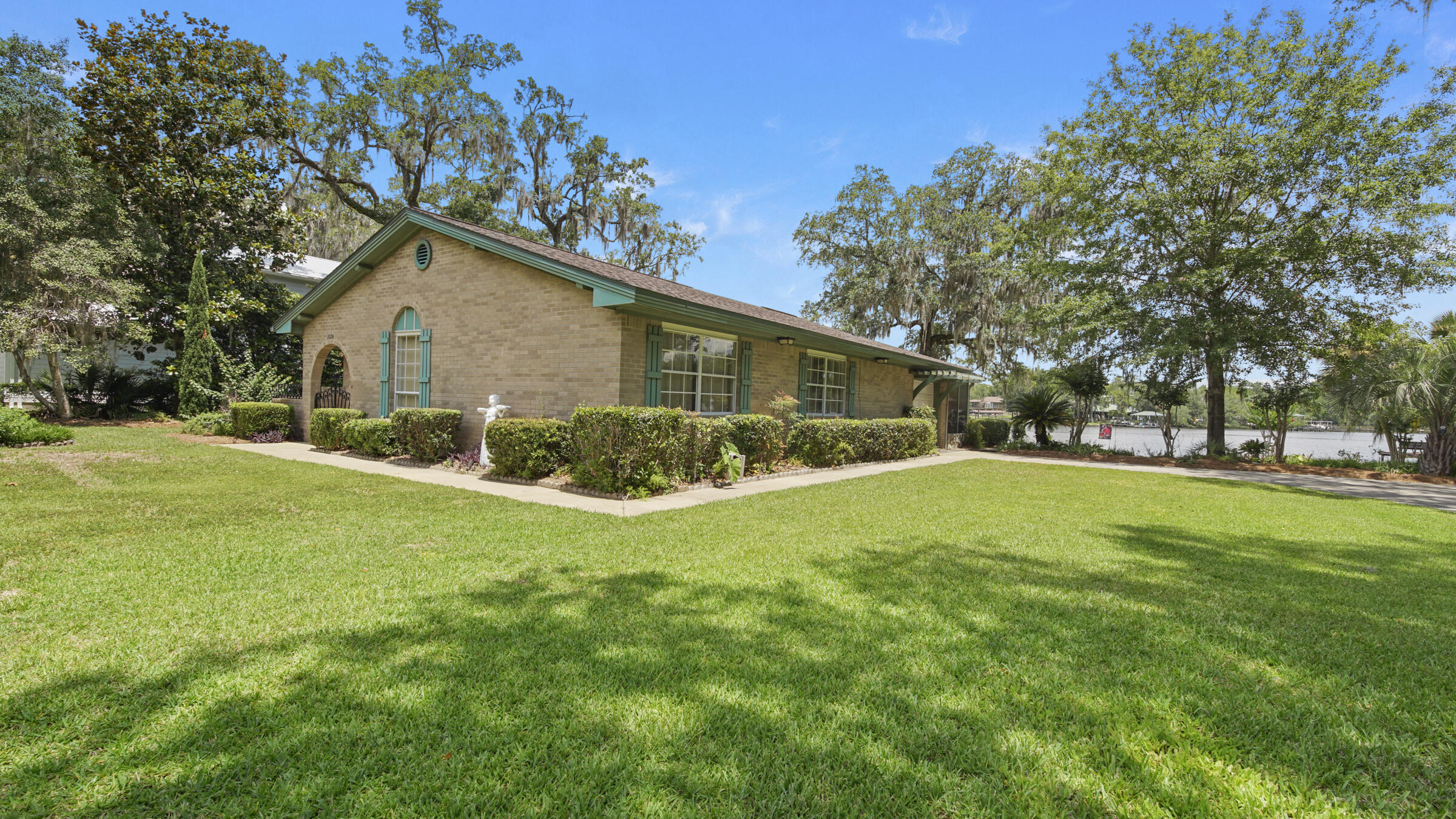 1124 Bay Grove Road Freeport, FL 32439 - Photo 2 of 37 a view of a house next to a big yard with large trees