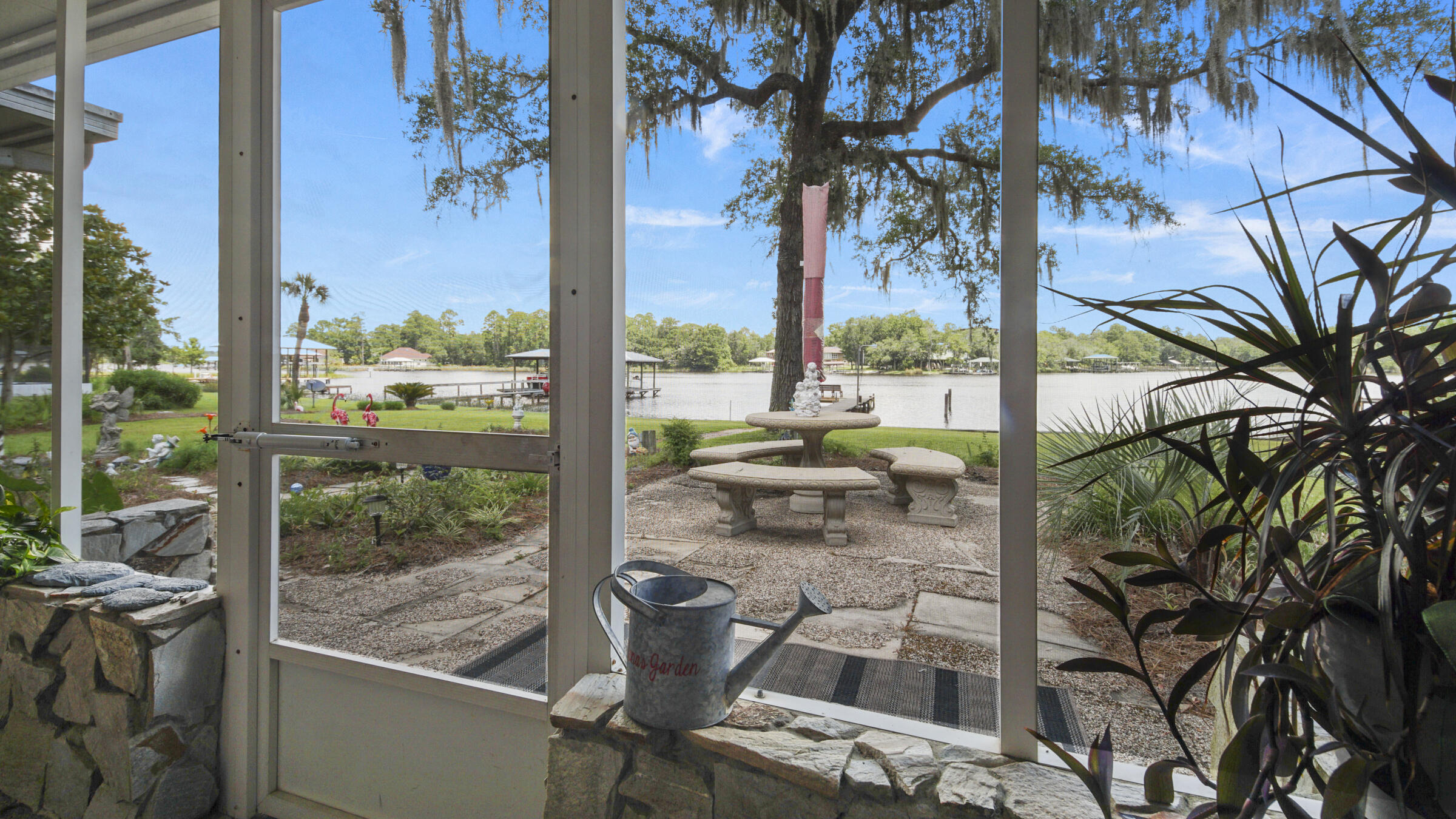 1124 Bay Grove Road Freeport, FL 32439 - Photo 24 of 37 a view of a porch with a floor to ceiling window next to a yard