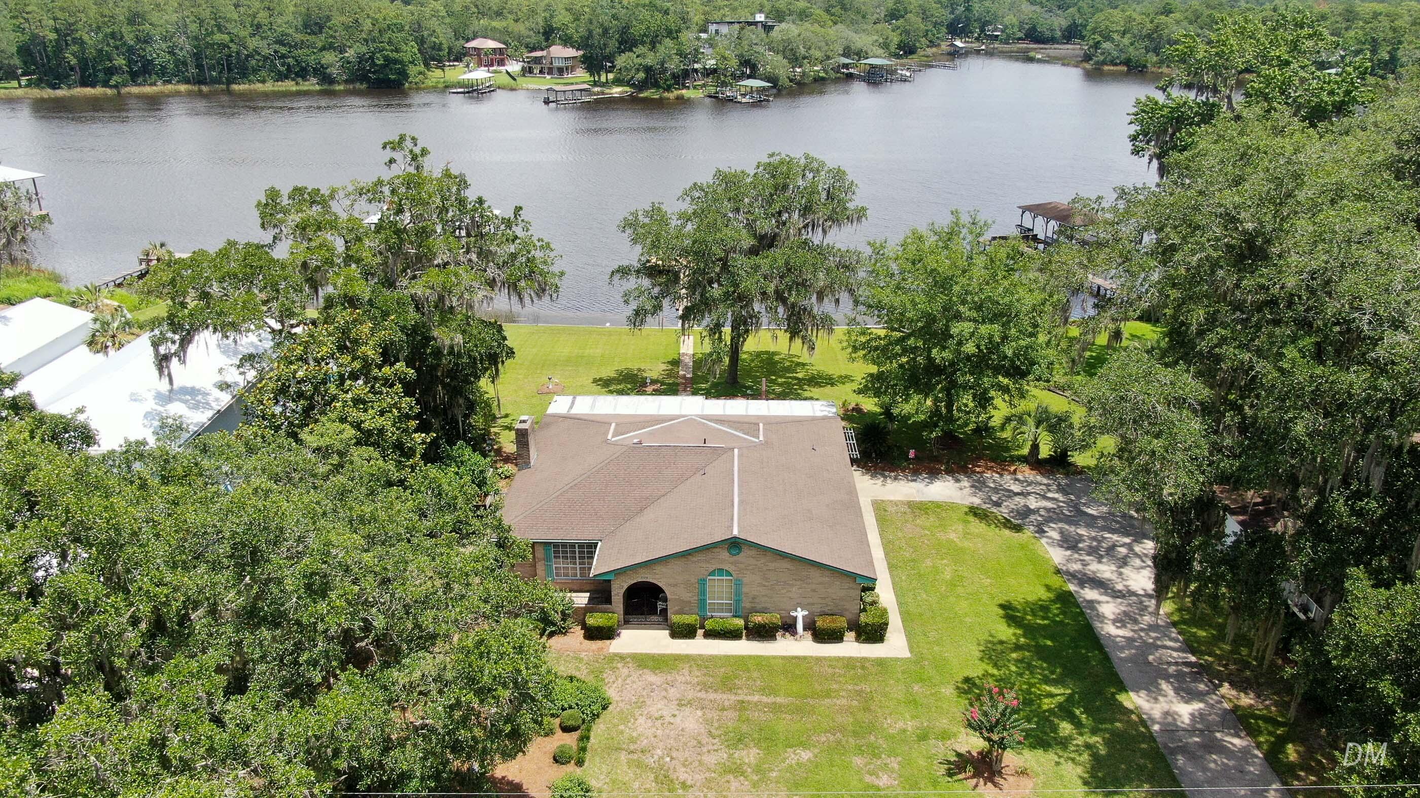 1124 Bay Grove Road Freeport, FL 32439 - Photo 3 of 37 an aerial view of a house with outdoor space and lake view