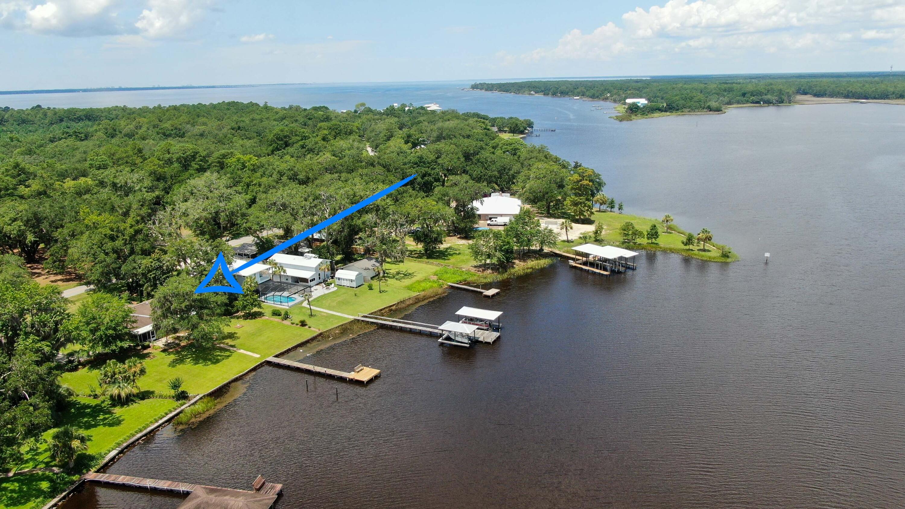 1124 Bay Grove Road Freeport, FL 32439 - Photo 32 of 37 view of a lake with a floor to ceiling windows