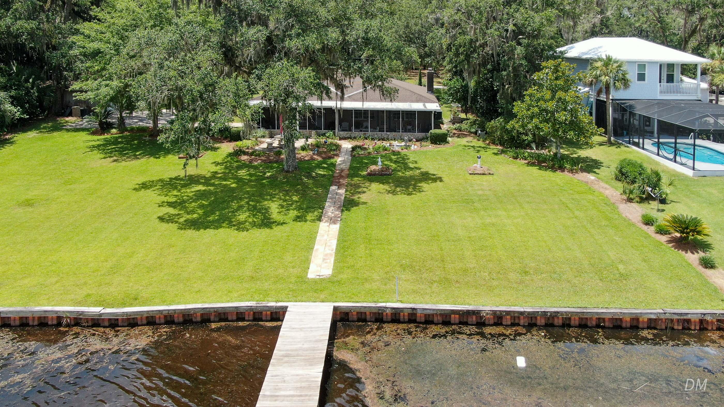 1124 Bay Grove Road Freeport, FL 32439 - Photo 5 of 37 a view of a swimming pool with a garden