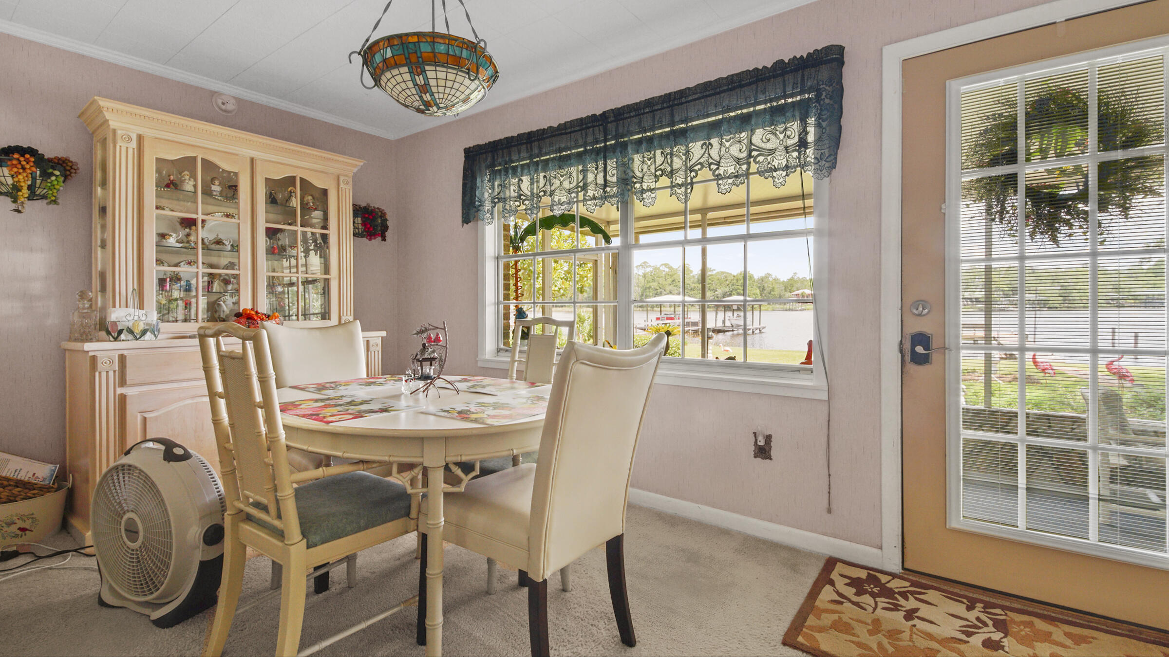 1124 Bay Grove Road Freeport, FL 32439 - Photo 8 of 37 a dining room with furniture a chandelier and wooden floor