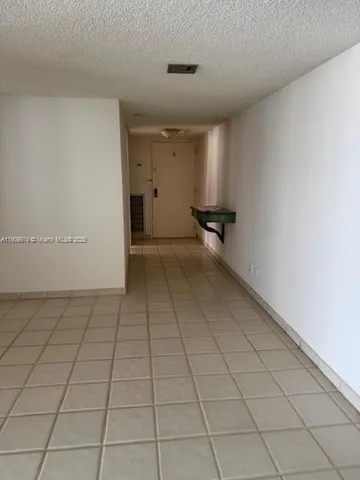 a kitchen with kitchen island granite countertop a refrigerator stove and sink