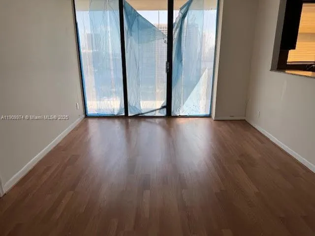 a view of an empty room and wooden floor