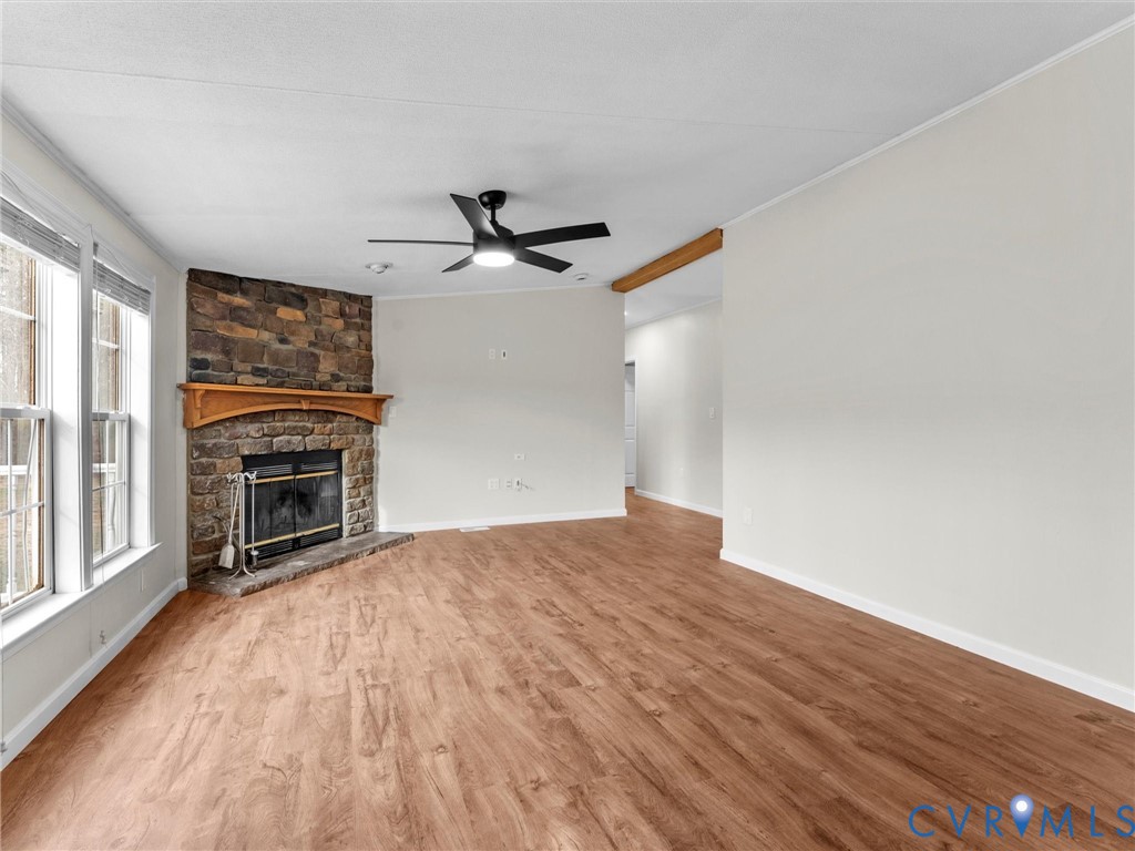 4772 Carsley Road Waverly, VA 23890 - Photo 3 of 38 Unfurnished living room with crown molding, wood f