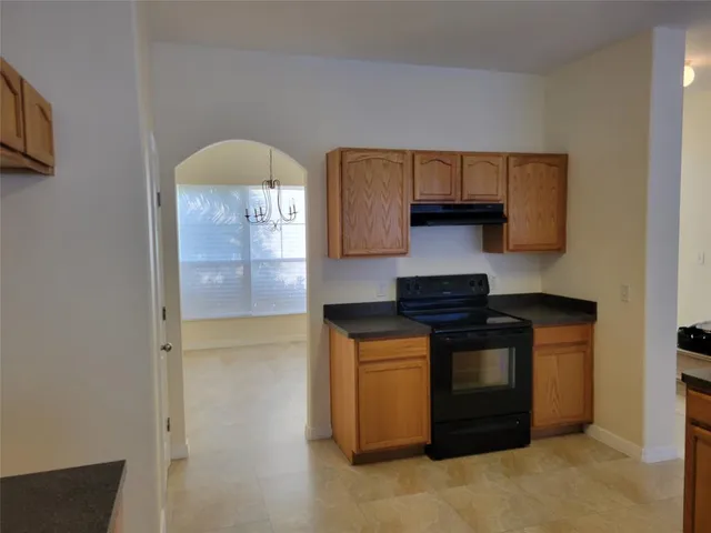 a kitchen with stainless steel appliances granite countertop a stove and a refrigerator