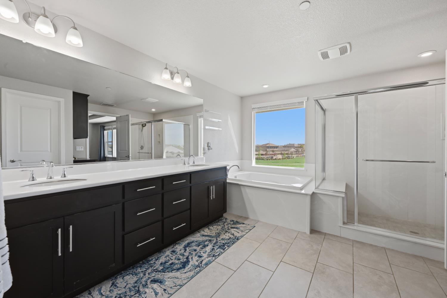 2012 Van Ruiten Drive Lodi, CA 95242 - Photo 29 of 49 a spacious bathroom with a shower sink and mirror