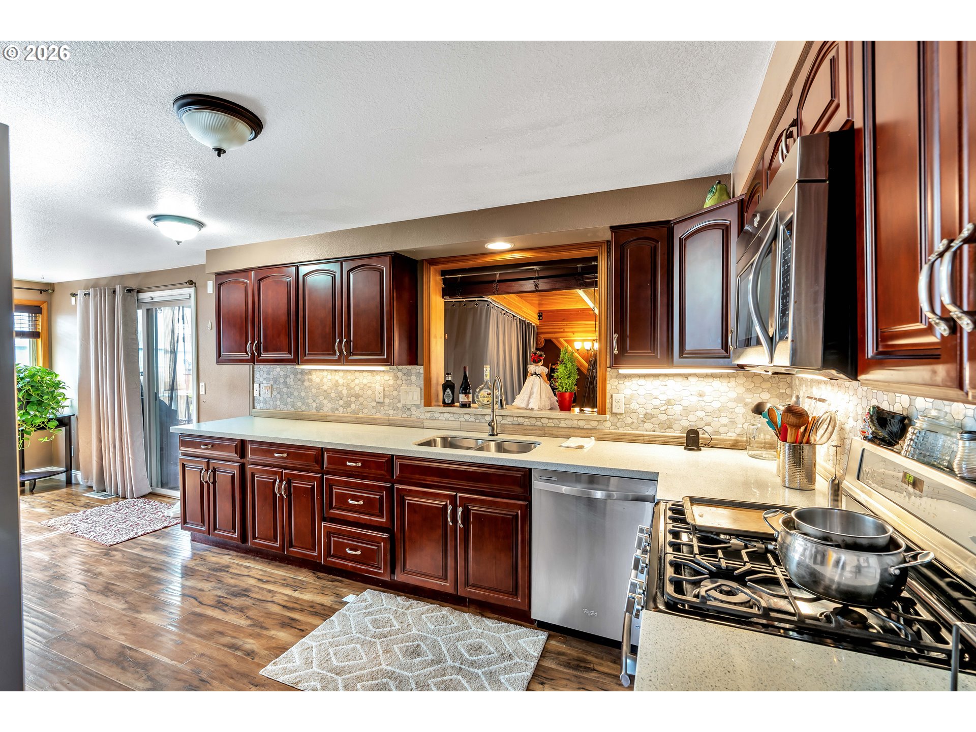 21498 Southwest Jay Street Beaverton, OR 97003 - Photo 15 of 47 a large kitchen with stainless steel appliances granite countertop a stove and a sink